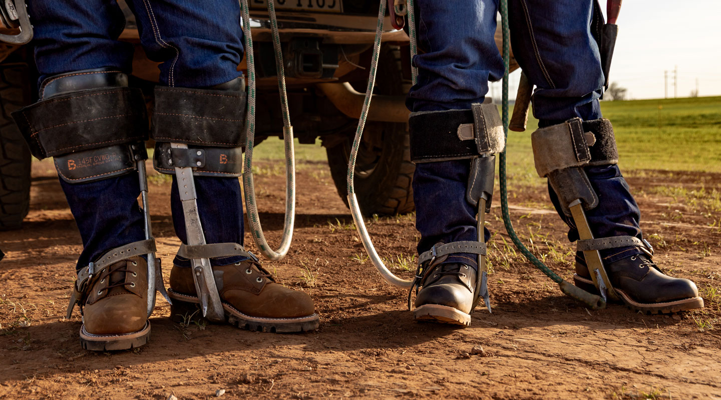 Two men wearing Chippewa Logger boots.